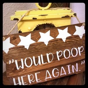 Wood sign "would poop here again" 5 star rating.